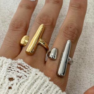 18K gold and silver open rings worn on female hand close-up elongated asymmetrical design