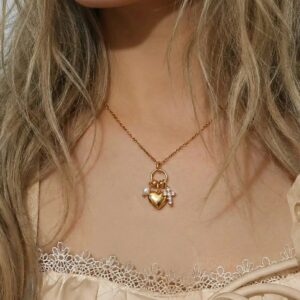 18K gold heart necklace worn on model at collarbone, close-up front view, paired with lace camisole, delicate jewelry styling