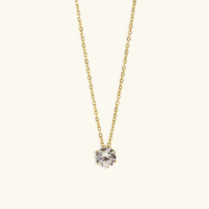 18K gold solitaire necklace with round CZ diamond pendant, front overhead view on light beige background, thin delicate gold chain