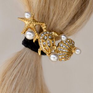 18K gold marine hair cuff worn on blonde woman's low ponytail starfish turtle shell charm