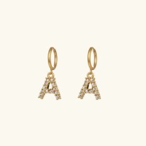 18K gold initial letter A earrings with diamond simulant pave rhinestone setting on light beige background - personalized drop hoop style