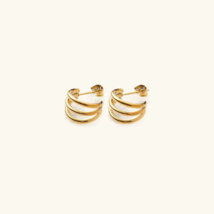 18K gold triple hoop stud earrings flat lay top-down view showcasing three layered hoops with polished gold finish on light beige background