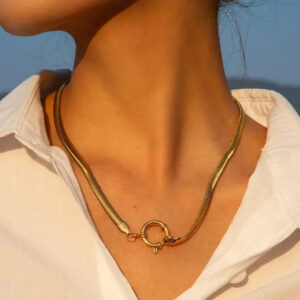 18K gold necklace worn on model female neck white shirt indoor choker length style front view