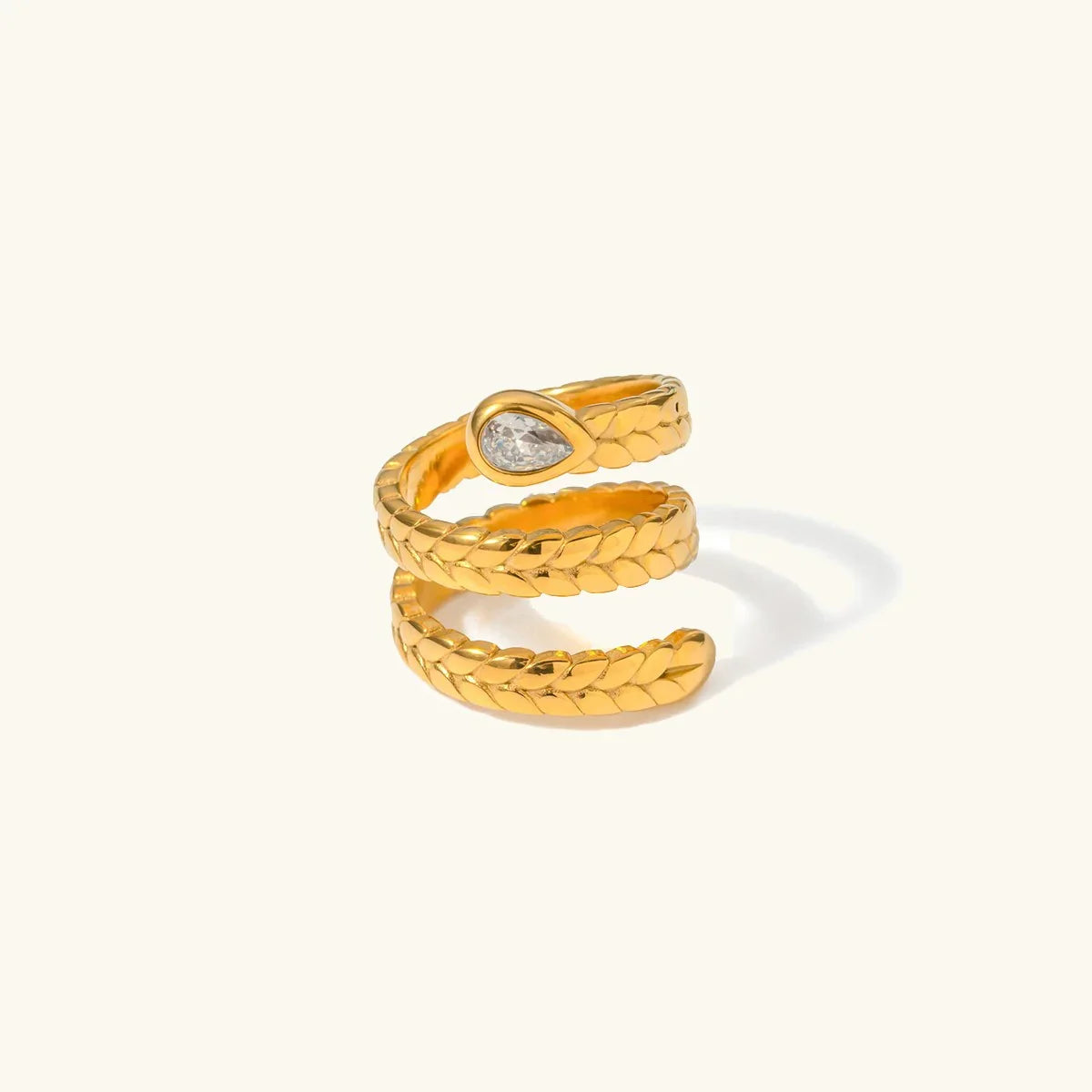 18K gold serpent wrap ring front view three-layer coil design with diamond simulant accent flat lay