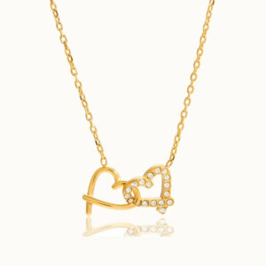 18K gold intertwined hearts charm necklace flat lay overhead view with crystal pavé pendant on white background