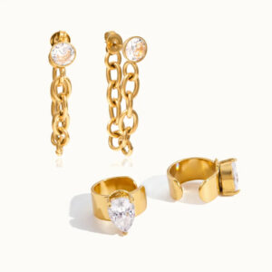 Complete 18K gold earring bundle flat lay showing all pieces, chain drop studs and teardrop ear cuffs with polished gold finish display