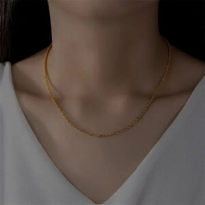 14K gold twisted chain necklace worn on model collarbone close-up portrait white v-neck