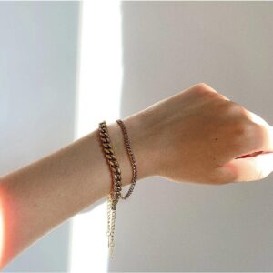 Layered double bracelet set worn on wrist showing thick curb chain paired with thin cable chain design and dangling tail extension