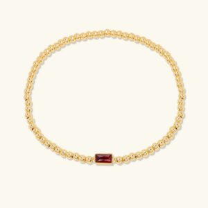 18K gold birthstone bracelet with rectangular gemstone, flat lay product photography on light background, showcasing beaded chain design