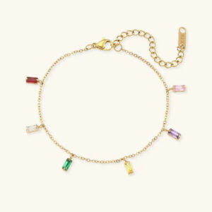 18K gold gemstone bracelet featuring baguette-cut multi-color charms on delicate cable chain, flat lay overhead view
