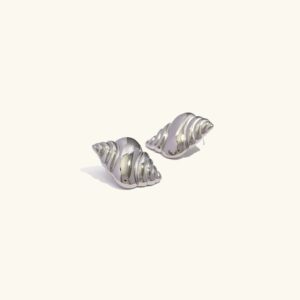 Lustrous conch shell silver stud earrings with mirror-polished finish on plain off-white background - hypoallergenic jewelry
