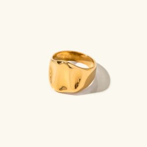 18K gold sculptural signet ring flat lay front view polished irregular rounded square face plain background