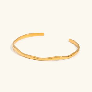 18K gold curved cuff bangle polished finish open-ended design flat lay top view