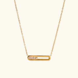 18K gold sculpted pendant necklace flat lay with hollow rectangular frame and diamond simulants on white background