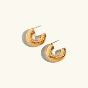 18K gold hammered hoop earrings front view flat lay professional product photography with polished finish and textured C-shaped design