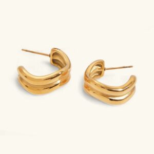 18K gold double-curve hoop earrings flat lay, polished finish, plain background, sculptural dual-curved design