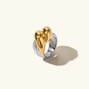 18K gold and silver two-tone twisted heart ring front view polished finish on plain background elegant jewelry