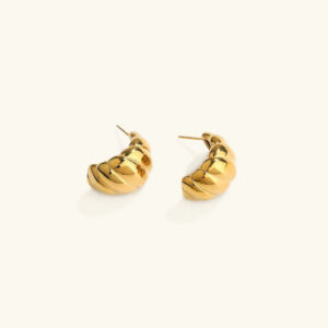 18K gold croissant huggie earrings with twisted ribbed texture, flat lay top-down view on white background showing intricate design details