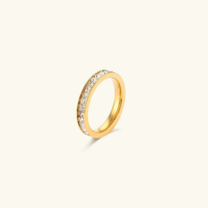 18K gold linear eternity ring with baguette CZ diamonds on plain background
