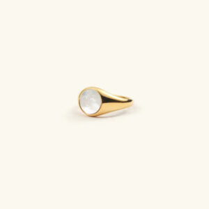 18K gold mother of pearl ring flat lay - side view with polished gold band and round white pearl inlay on light studio background