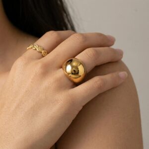 18K Gold Dome Ring Worn on Female Model - Close-up Hand on Shoulder with Twisted Ring Accent