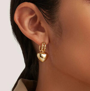 18K gold heart hoop earrings worn on ear close-up side view female model demonstration