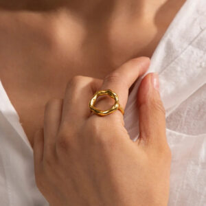 Artemis 18K gold adjustable ring worn on index finger close-up styling shot
