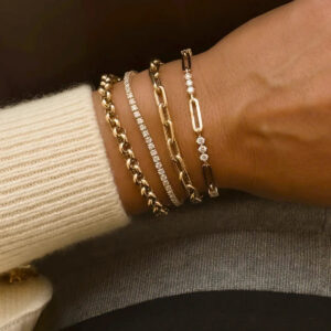 Woman wearing 18K gold diamond bracelet with cubic zirconia on wrist close-up side view