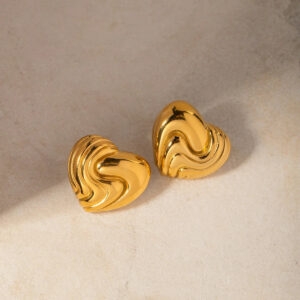 Wavy heart gold stud earrings oblique angle view showing bright shiny gold finish and raised wave texture details