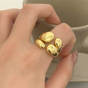 18K gold adjustable ring worn on hand - close-up lifestyle shot showing open band design and shiny polished gold tone with natural lighting