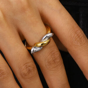 18K gold and silver twisted nail open ring worn on woman's fingers close-up, adjustable cuff design on hand