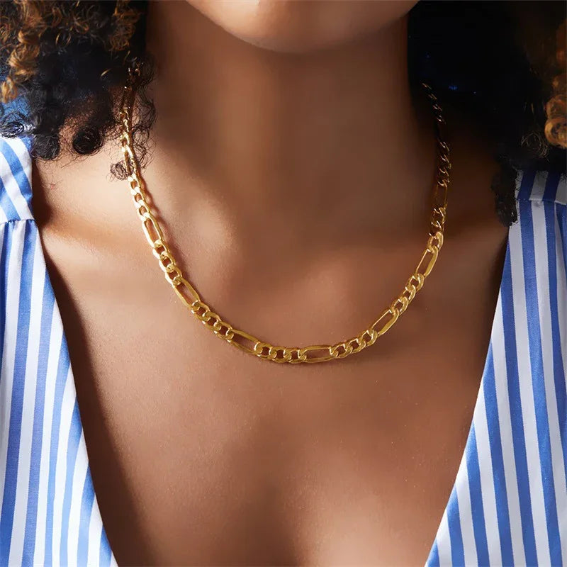 Medium figaro gold chain necklace front neck close-up on model wearing striped shirt classic link design