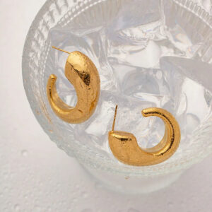 Textured matte 18K gold hoop earrings water resistant durability ice water glass closeup