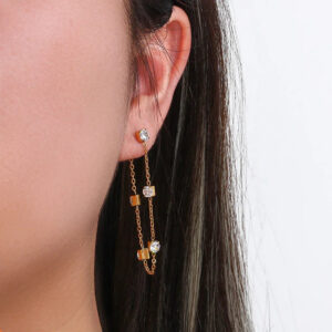 18K gold chain link dangle earrings worn on ear showing side profile and on-body styling effect with long dark hair