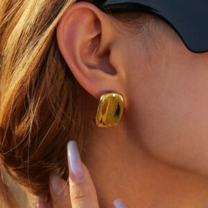 18K gold stud earrings on ear close-up side view female model wearing sunglasses chunky gold studs