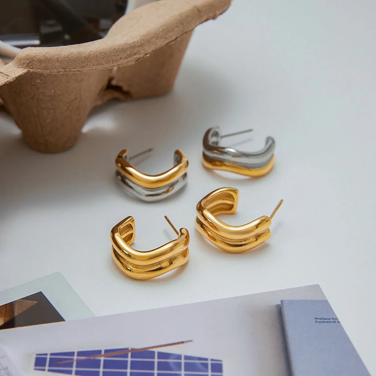 18K gold hoop earrings color options comparison, desktop flat lay, yellow gold and two-tone styles