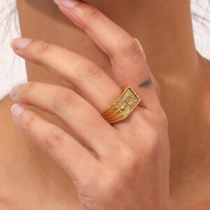 18K gold signet ring worn on hand - close-up shot showing fit and serpent engraving details
