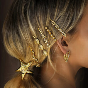 Gold beaded hair clips and starfish ocean-themed accessories worn by blonde model close-up side view