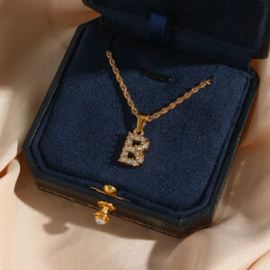 18K gold letter B initial diamond pendant necklace top-down display in dark blue velvet jewelry box with satin cloth and thin gold chain with diamond inlay