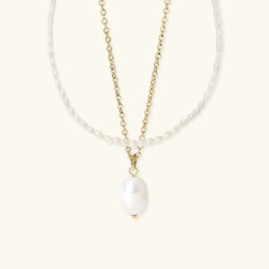 Ocean Radiance pearl necklace bundle flat lay display showing both pieces freshwater pearl choker and satellite chain pendant necklace on neutral background