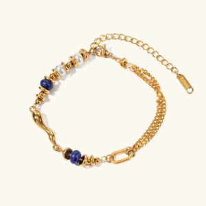 18K gold layered chain bracelet with freshwater pearls and blue bead accents, flat lay top-down view showing intricate multi-layer design on plain background