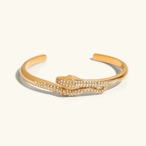 18K gold serpentine diamond bangle flat lay top view elegant open cuff bracelet with sparkling rhinestone details