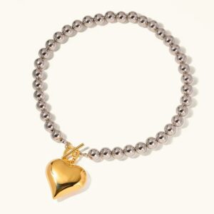 18K gold heart pendant chunky silver bead necklace flat lay on white background showcasing two tone design with polished heart charm and toggle clasp