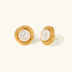 18K gold twisted pearl stud earrings flat lay view top-down light beige background round white freshwater pearls gold textured frame