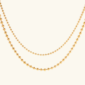 18K gold layered ball chain necklace with dual-strand beaded design displayed flat lay overhead view on white background