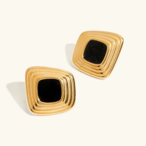 18K gold geometric twisted square stud earrings with black enamel inlay, flat lay product photography on white background