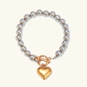 18K gold heart charm chunky bead bracelet two-tone flat lay front view silver and gold pendant