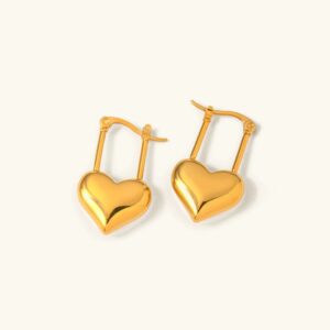 18K gold heart hoop earrings flat lay with polished bright gold finish and secure lever-back clasp on off-white background