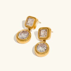 18K gold diamond drop earrings with geometric squared round design, flat lay on plain background showcasing polished gold finish and clear cubic zirconia stones