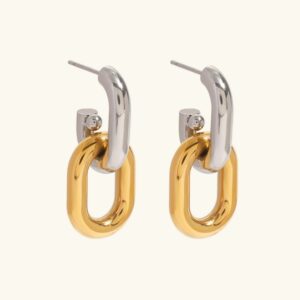 Two-tone 18K gold and silver double hoop earrings flat lay front view on plain beige background